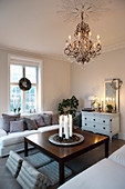 Christmas decorations and chandelier in classic, white living room