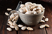 Dried white spanish beans in a ceramic cup