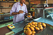 A man preparing street food, India