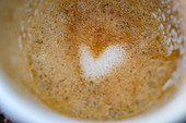 A heart pattern in leftover coffee foam