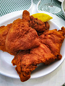 Fried chicken with lemon wedges