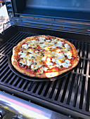 A pizza on a grill