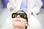 Beauty technician using laser treatment