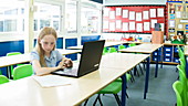 School girl using laptop