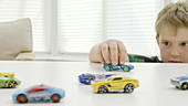 Boy playing with toy cars