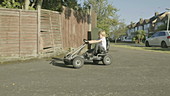 Boy playing outside on go-kart