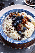 Millet with vegan milk and fruit, chocolate and nut