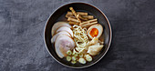 Ramen being served – ingredients and toppings being added