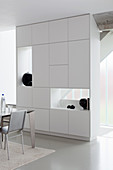 Cupboard with shelf modules used as partition in modern dining room