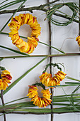 Wall hanging with roses and Chinese reed: Wreaths made from petals and Chinese reed
