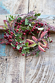 Wreath of hawthorn berries, ling and leafy branches