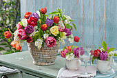 Colorful bouquet of tulips and bird cherry in a basket