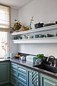 Classic kitchen with blue-green panelled cabinets