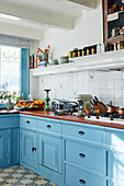 Classic country-house kitchen with light blue panelled cabinets