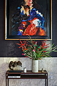 Abstract painting on black wall above console table