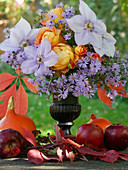 Autumn bouquet with roses, clematis and asters