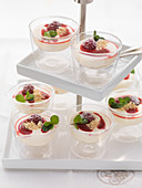 Mini raspberry cheesecakes in glasses on a cake stand