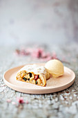 Vegan apple strudel with cranberries, pumpkin seeds, sweet shiso cream and vanilla ice cream