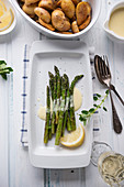 Grilled green asparagus with vegan Sauce Hollandaise with mini roast potatoes