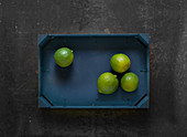 Limes in a wooden crate