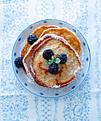 Pancakes with blackberries and icing sugar