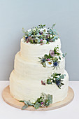 A three-tier wedding cake decorated with flowers