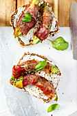 Bread topped with avocado and bacon
