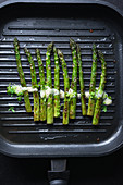 Green asparagus with vegan hollandaise and cress in a grill pan