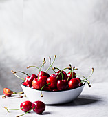 Cherries in a bowl against a light background