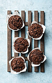 Chocolate muffins on blue background top view