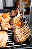 Sausages and ribs on a grill rack