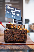 Dark banana bread with nuts on a restaurant counter