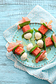 Melon balls and mozzarella on wooden skewers