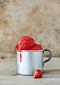 Homemade strawberry sorbet in a metal mug