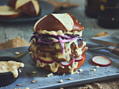 Lye roll burger with pork, cheese and onions