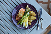 White and green asparagus with salmon, jacket potatoes and hollandaise sauce
