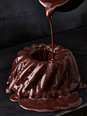 Pouring chocolate on a marble cake