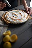 Meringue topping on a lemon tart being scorched