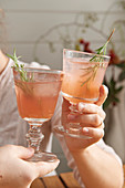 Pink fizz with rosemary sprigs