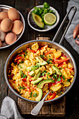 Scrambled eggs with potatoes, pepper and avocado