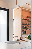 Modern kitchen area with integrated sink and open shelves