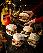 Sticky sausage baps with beer-braised onions