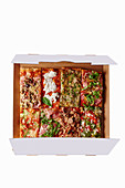 Various pieces of pizza in a box