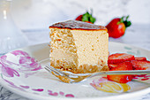 A piece of amarula cream cheese cake with strawberries
