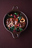 Laurel braised veal knuckle slices with cassis pearl onions