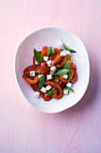 Roasted tomato and pepper salad with feta and grains of paradise