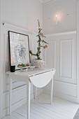 Drop-leaf table against panelled wainscoting in white living room