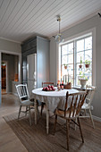Round table and chairs with turned legs and spokes in rustic kitchen-dining room