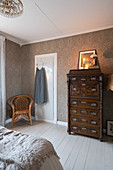 Antique chest of drawers in granny-chic bedroom