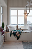 Cosy window seat on storage bench in winter